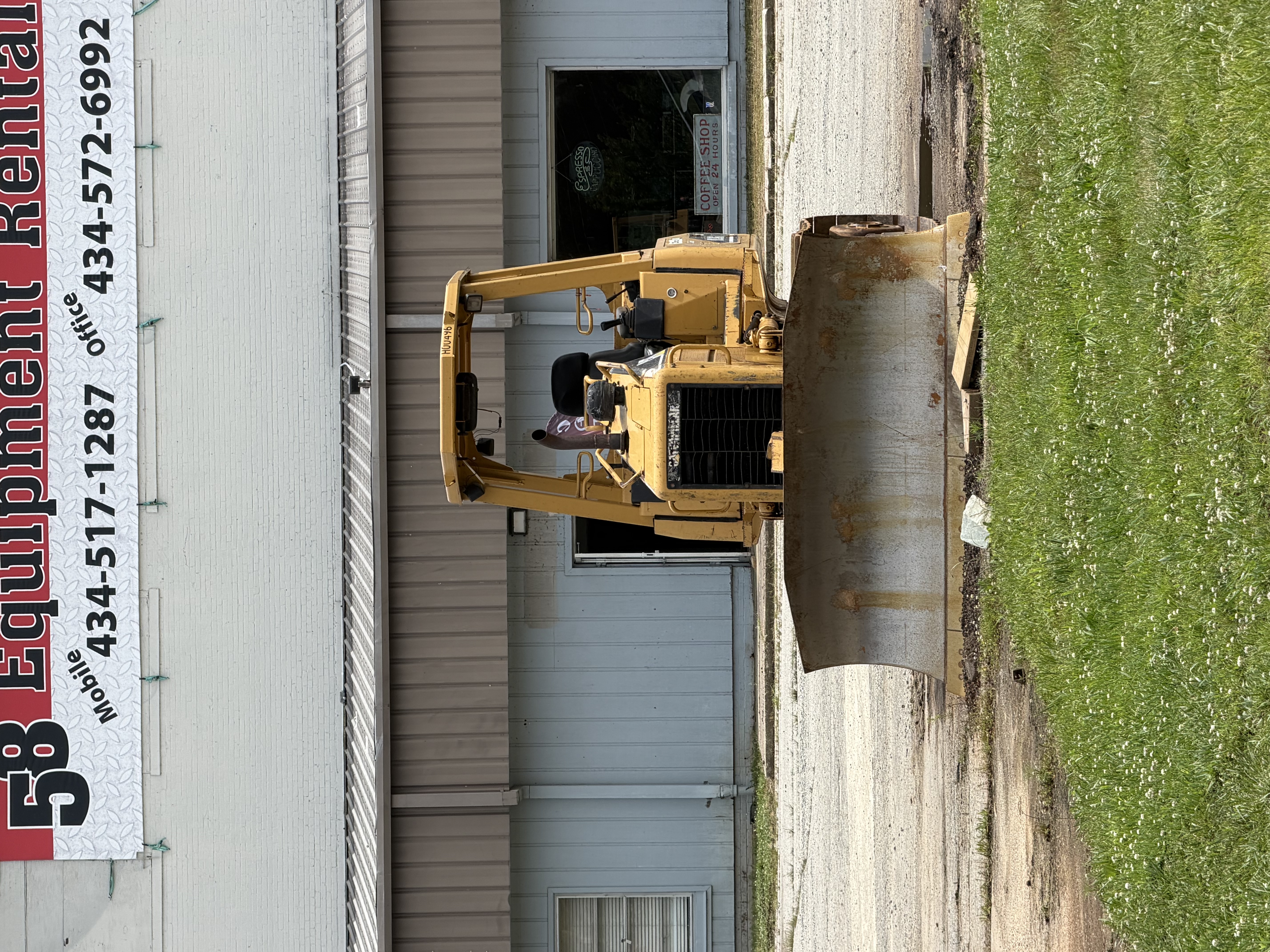 Caterpillar small dozer with 6-way blade in front of the 58 Equipment Rentals building, Halifax County VA